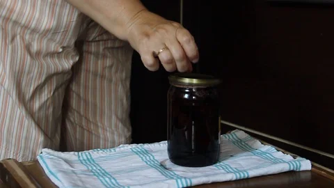 Preparation of strawberry jam. Cook jam. roll up strawberry jam jars using a Stock Footage 109336982