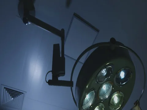 Preparation for surgery. the nurse adjusts the light on the patient Stock Footage 74017770