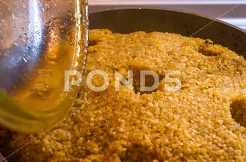 Preparation of Uzbek pilaf - evaporation of water from rice, close up Stock Photos