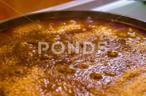 Preparation of Uzbek pilaf - evaporation of water from rice, close up Stock Photos