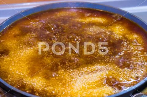Preparation of Uzbek pilaf - evaporation of water from rice, close up Stock Photos