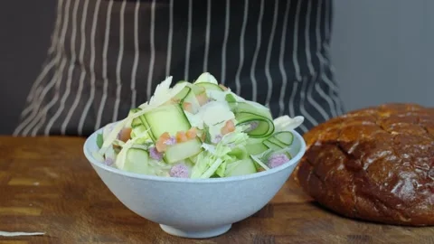 Preparation of vegetarian salad. Adding cheese to salads. Video stock 235223734