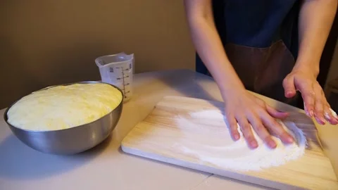 Preparation of the working surface for kneading the dough. Sprinkles flour on Stock Footage 221172152