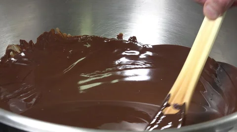 Preparation of a Yule log, closeup of sterring chocolate Stock Footage 57905124