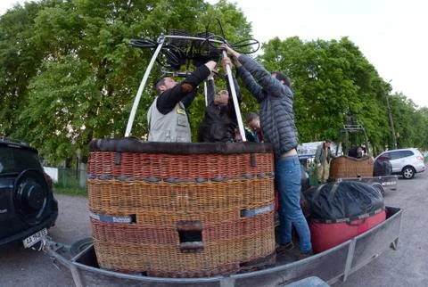 Preparations for ballooning: pilot checking gas burners and rigging of a balloon Stock Photos