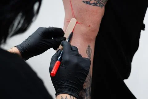 Preparations prior to the tattoo session with marks on the skin in red ink Stock Photos