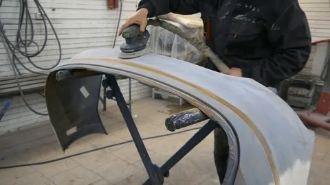 Prepare the bumper for painting Stock Footage 93170945