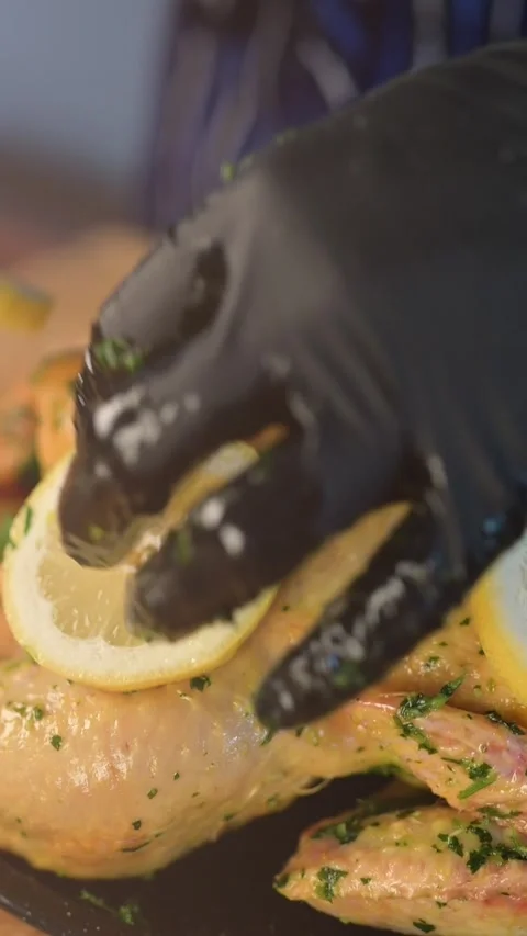 Prepare Chicken with lemon Before Roasting Vertical slow motion video Stock Footage 134056465