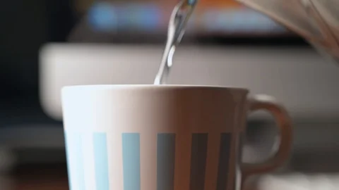 Prepare a cup of tea while working on the computer Stock Footage 127649880