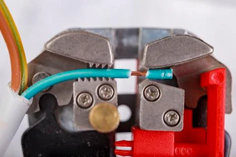 Prepare the electric wire for installation with a wire stripper. Electrical a Stock Photos