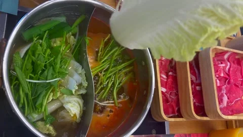 Prepare hot pot with fresh vegetables and sliced meat. Cabbage and herbs are Stock Footage 301518363