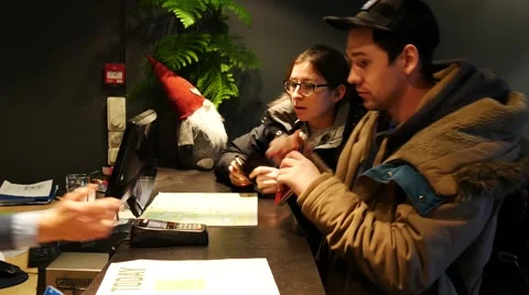 Prepare for payment with payment terminal during Hotel Check-in Stock Footage 61544834