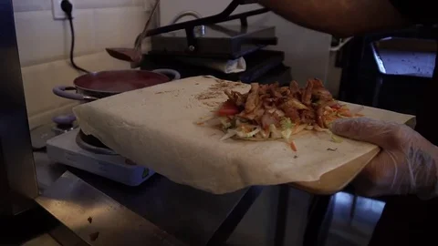 Prepare shawarma, meat on a spit, cut the shred vegetables for shawarma Видео 83966692