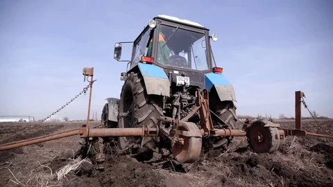 Prepare soil for growing by tractor Stock Footage 73452671