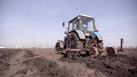 Prepare soil for growing by tractor Stock Footage 73453386