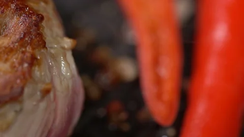 Prepare steak with hot peppers in a pan. slow motion 動画素材 101660135