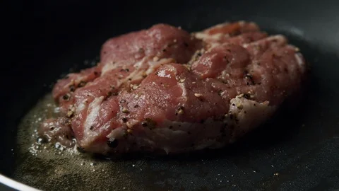 Prepare a steak from raw pork meat on pan a hot saucepan Stock Footage 120214474