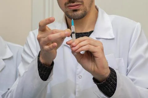 Prepare the syringe for injection. Load solution into the syringe. Syringe in Stock Photos