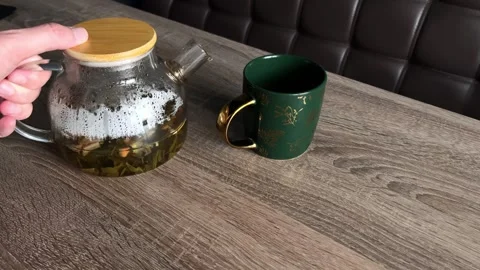 The prepared fruit tea is poured into a cup. Homemade tea party. Stock Footage 304160951