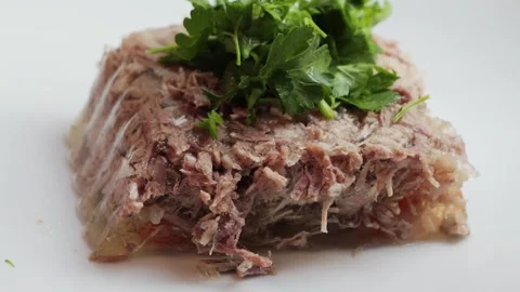 Prepared homemade beef aspic on plate, topping with parsley and dill. Stock Footage 327205237