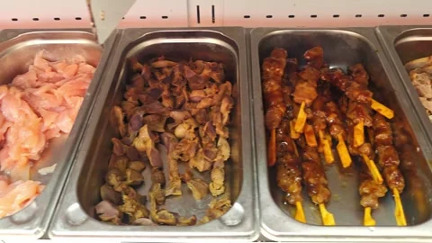 Prepared meat dishes displayed in a Chinese buffet counter, casual dining, .. Stock Footage 337796024