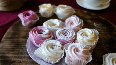 Prepared meringues or marshmallows or cupcakes in pastry shop on wooden table Stock Footage 139288401