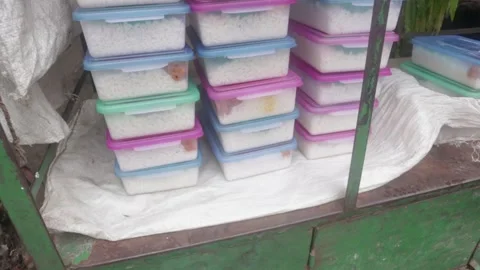Prepared plastic transparent lunch boxes orderly with meal at street Stock Footage 156456169
