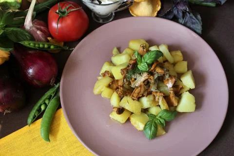 Prepared rustic dish with fried potatoes and mushrooms with herbs Stock Photos