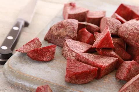 Prepared uncooked beetroot on chopping board Stock Photos