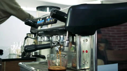Prepares espresso pouring from coffee machine in coffee shop Stock Footage 138858324