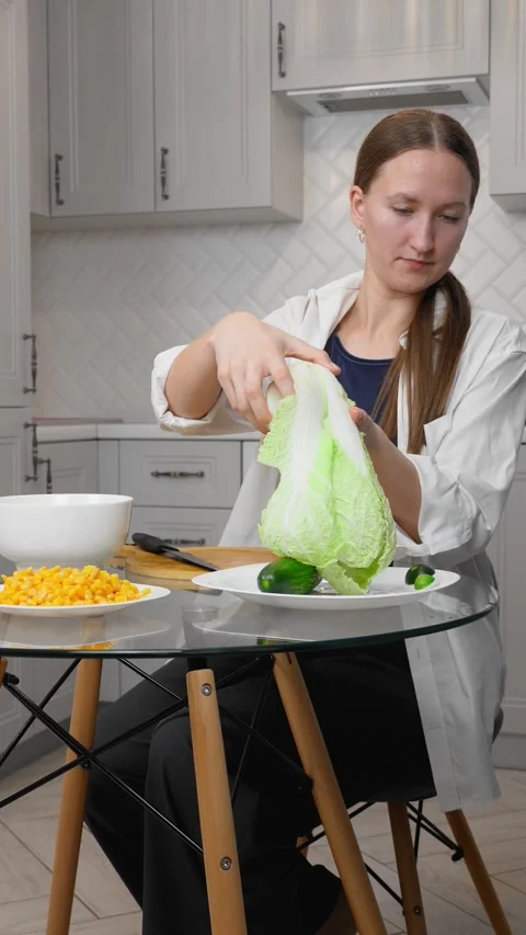 Prepares salad, cuts vegetables, slices cucumbers 스톡 동영상 308321507