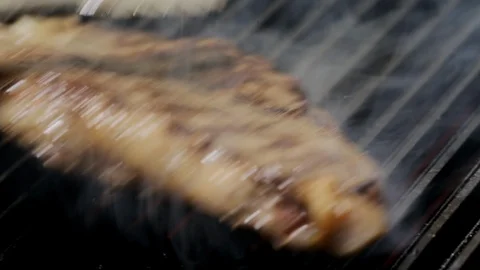 Prepares steak on the grill Video stock 104084087