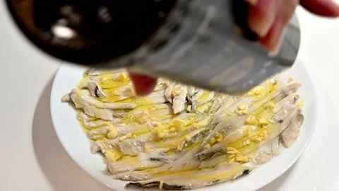 Preparing anchovies in vinegar. Adding garlic and parsley Stock Footage 219720734
