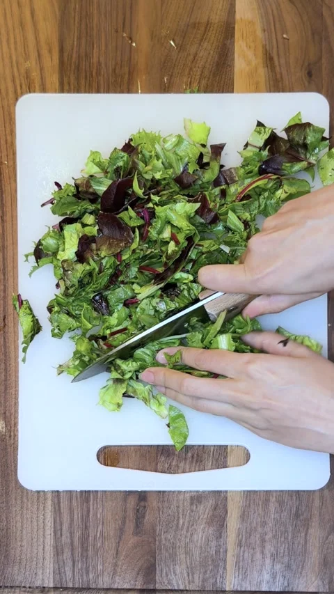 Preparing and Chopping Fresh Spring Mix Greens for Salad-Vertical Stock Footage 333789529