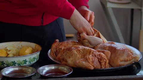 Preparing and cooking chicken in a traditional outdoor oven. Stock Footage 310017469