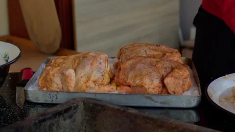 Preparing and cooking chicken in a traditional outdoor oven. Stock Footage 310017630