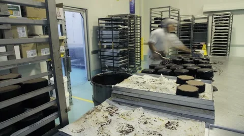Preparing and decorating cakes at a commercial bakery Stock Footage 1087256