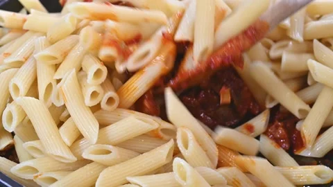 Preparing and heating macaroni with tomato Stock Footage 219674531