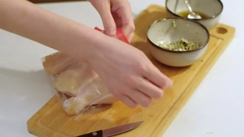 Preparing and marinating raw chicken meat, packing in plastic bag. Cooking food Stock Footage 256457305