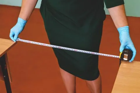Preparing and measuring the distance between tables in a school academy Stock Photos