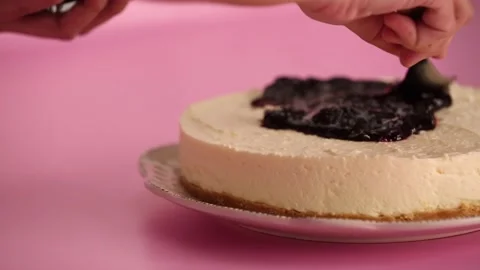 Preparing and serving a cheesecake with berry toppings Stock Footage 133807728