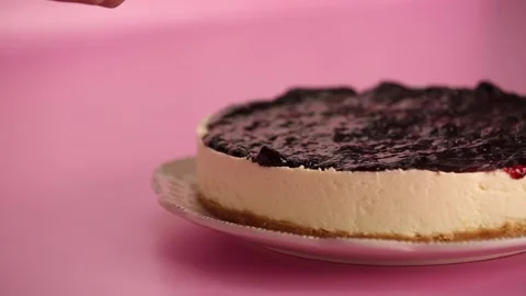 Preparing and serving a cheesecake with berry toppings Stock Footage 133807834