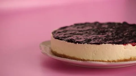 Preparing and serving a cheesecake with berry toppings Stock Footage 133807892