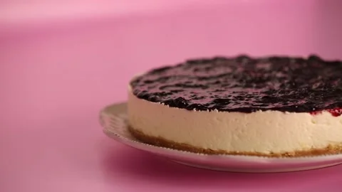 Preparing and serving a cheesecake with berry toppings Stock Footage 133808035