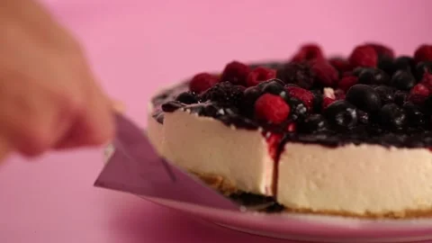 Preparing and serving a cheesecake with berry toppings Stock Footage 133808349