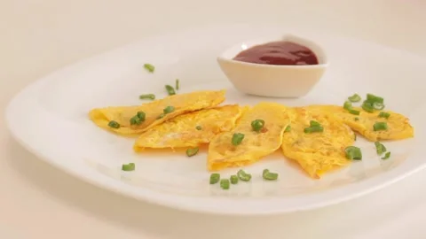 Preparing and serving a mini omelette Stock Footage 133815566