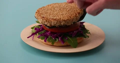 Preparing and serving quinoa burger Stock Footage 132146136