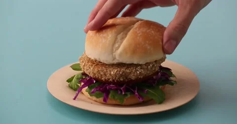 Preparing and serving quinoa burger Stock Footage 132146188