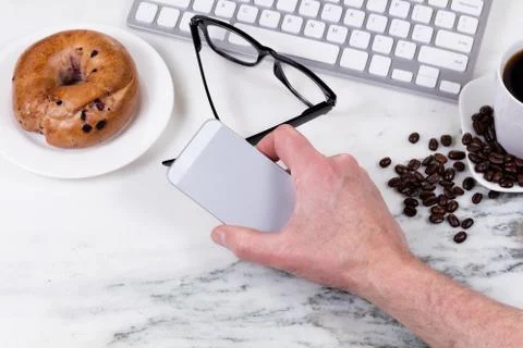 Preparing to answer phone while working at home on white marble countertop Stock Photos