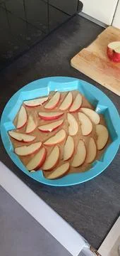 Preparing apple pie in a silicone mold at home before baking, mobile photo. C Stock Photos